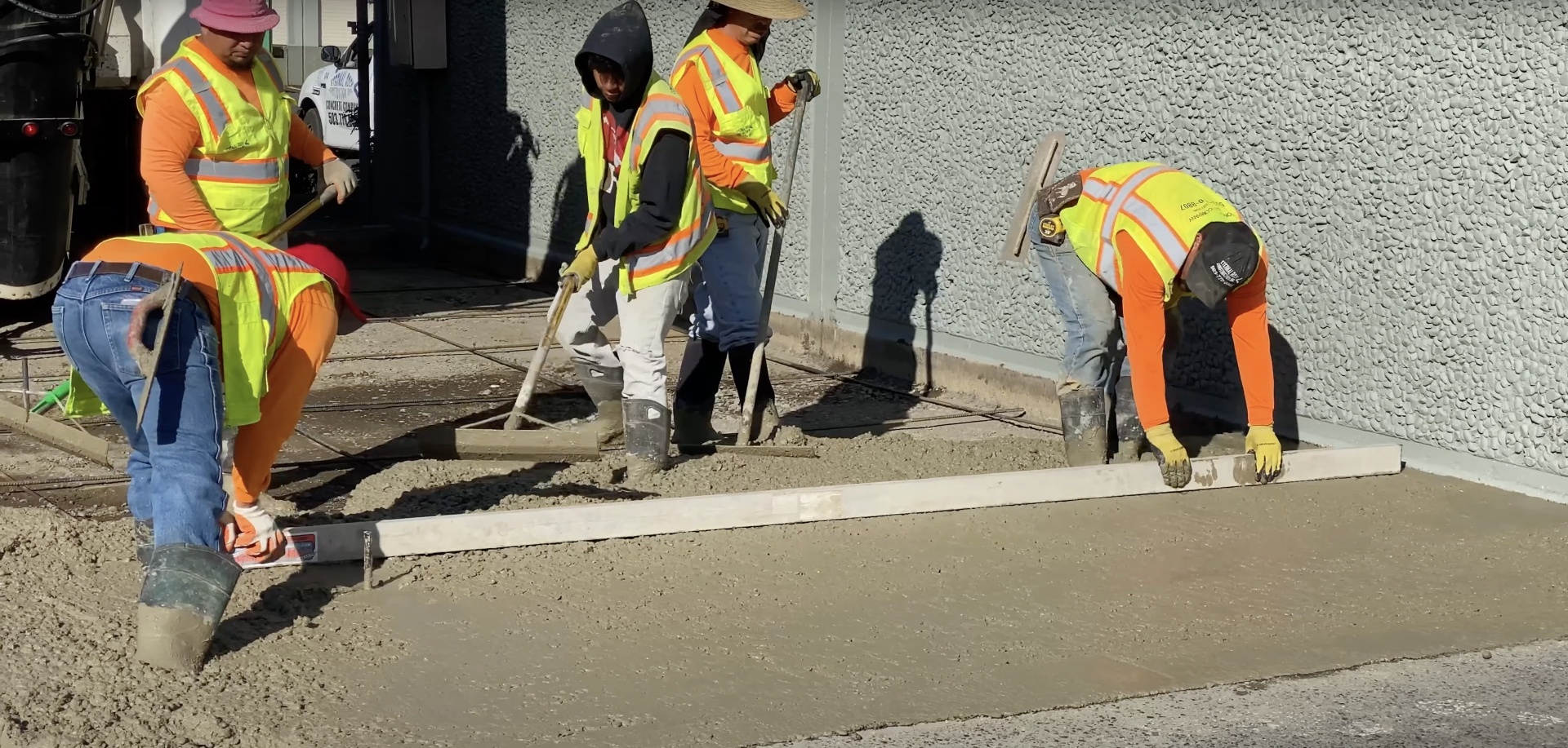 Expert concrete installation and finishing services Professional concrete finishing crew working on large commercial concrete project